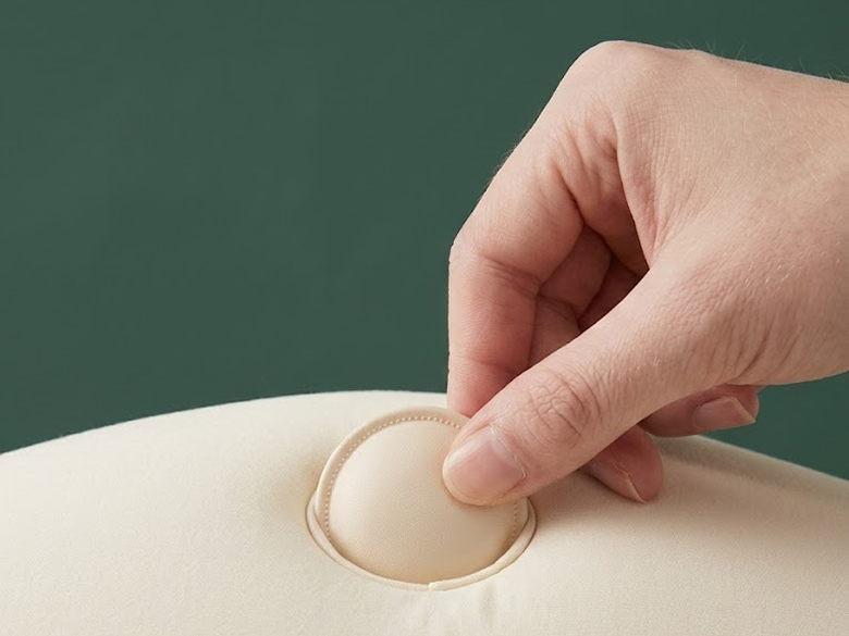 Hand sliding a thin scent insert into the pillow pocket