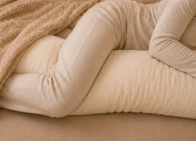 Beside body pillow supporting the legs while side sleeping